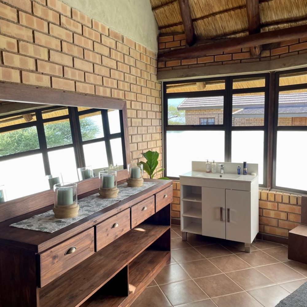 Lodge bathroom with vanity and brick walls