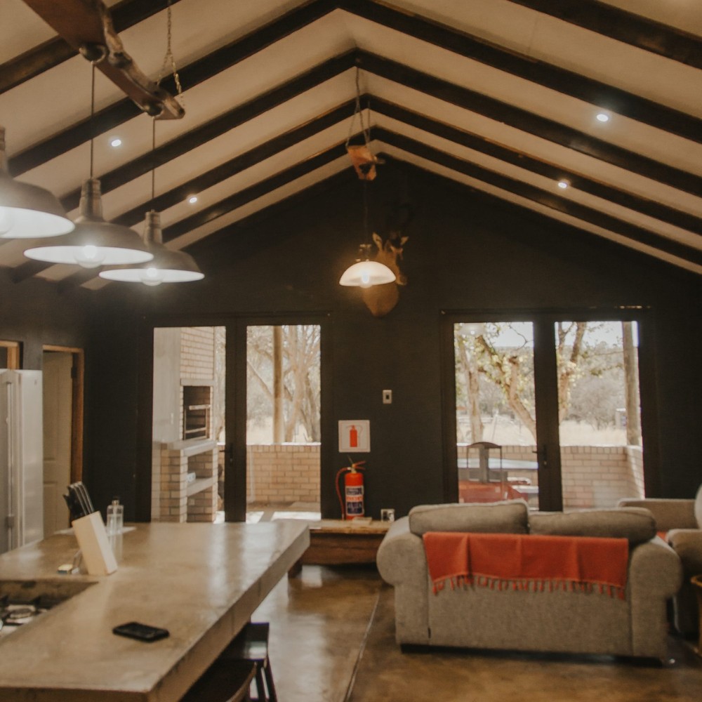 Waterberg Lodge — open-plan lounge with exposed beams